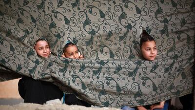 Palestinian girls watch participants in a summer physical training camp run by Hamas during their summer vacation in Gaza City. Mohammed Abed / AFP
