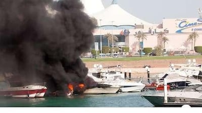 A boat burns in its berth near Marina Mall in Abu Dhabi. Some owners have criticised the lack of safety equipment.