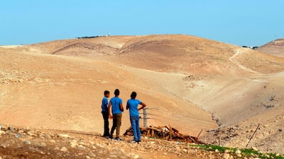 Palestinian children stand near remains of a protest camp near the West Bank village of Khan Al Ahmar. AFP