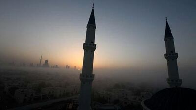 Minarets of the under construction Farooq Mosque during the sunrise in Al Safa area in Dubai. The Dubai skyline can be seen on the left side.