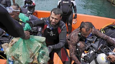 Volunteer divers collect trash from the ocean floor of the Abu Dhabi Free Port as part of the Dive Together To Protect Our Marine Environment’ initiative. Antonie Robertson/The National