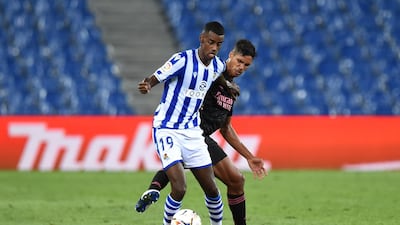 Alexander Isak of Real Sociedad is challenged by Raphael Varane of Real Madrid. Getty Images