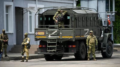 Russian soldiers guard an area of Kherson in May this year. AP