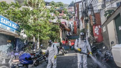 Workers perform disinfection operations at Dona Marta favela in Rio de Janeiro, Brazil. Bloomberg