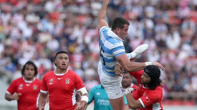 Emiliano Boffelli (top) of Argentina and Latiume Fosita of Tonga jump as they struggle to catch the ball during the Rugby World Cup match between Argentina and Tonga at Hanzono Stadium in Higashiosaka, Japan. EPA