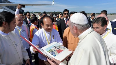 Pope Francis receives a gift as he prepares to depart for Dhaka. Osservatore Romano / Handout via Reuters