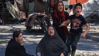 Palestinians gather at the UN-run Al Razi school in Nuseirat refugee camp after an Israeli strike. AFP