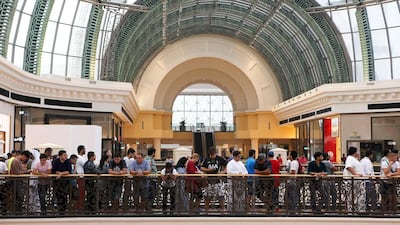 A crowd waits outside the Apple store before the launch of iPhone 7 at the Mall of the Emirates. Pawan Singh / The National