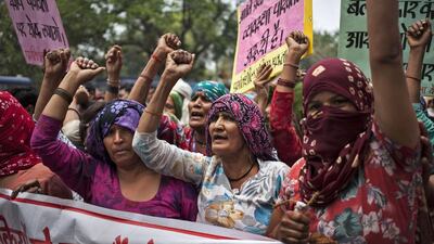 Indian Dalit women shout slogans during a protest against a gang-rape of four Dalit girls in Haryana’s Hisar district on May 11, 2014. AP Photo / Tsering Topgyal