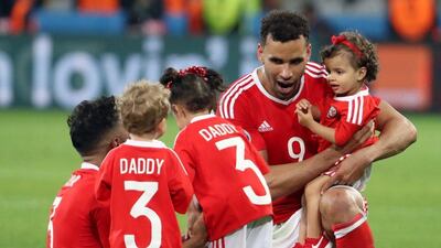 Hal Robson-Kanu, right, and Neil Taylor of Wales celebrate on the pitch with their children after the UEFA EURO 2016 quarter final match between Wales and Belgium at Stade Pierre Mauroy in Lille Metropole, France, 01 July 2016. (EPA)