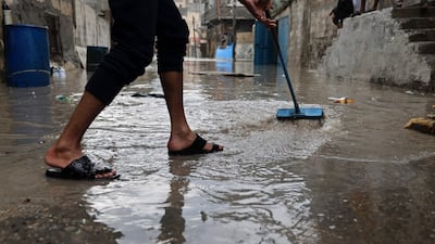 Clearing floodwater after heavy rain at Al Shatee refugee camp in Gaza City. AFP
