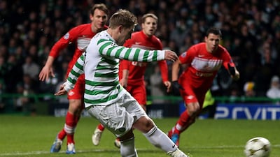 Celtic's Kris Commons scores the penalty which put his side through to the last-16 of the Champions League.