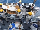 Wreckage of crashed cargo plane found in Arabian Sea as search continues for five crew