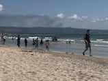 'Just chill': Tyre beachgoers bronze against backdrop of smoke and Israeli occupation